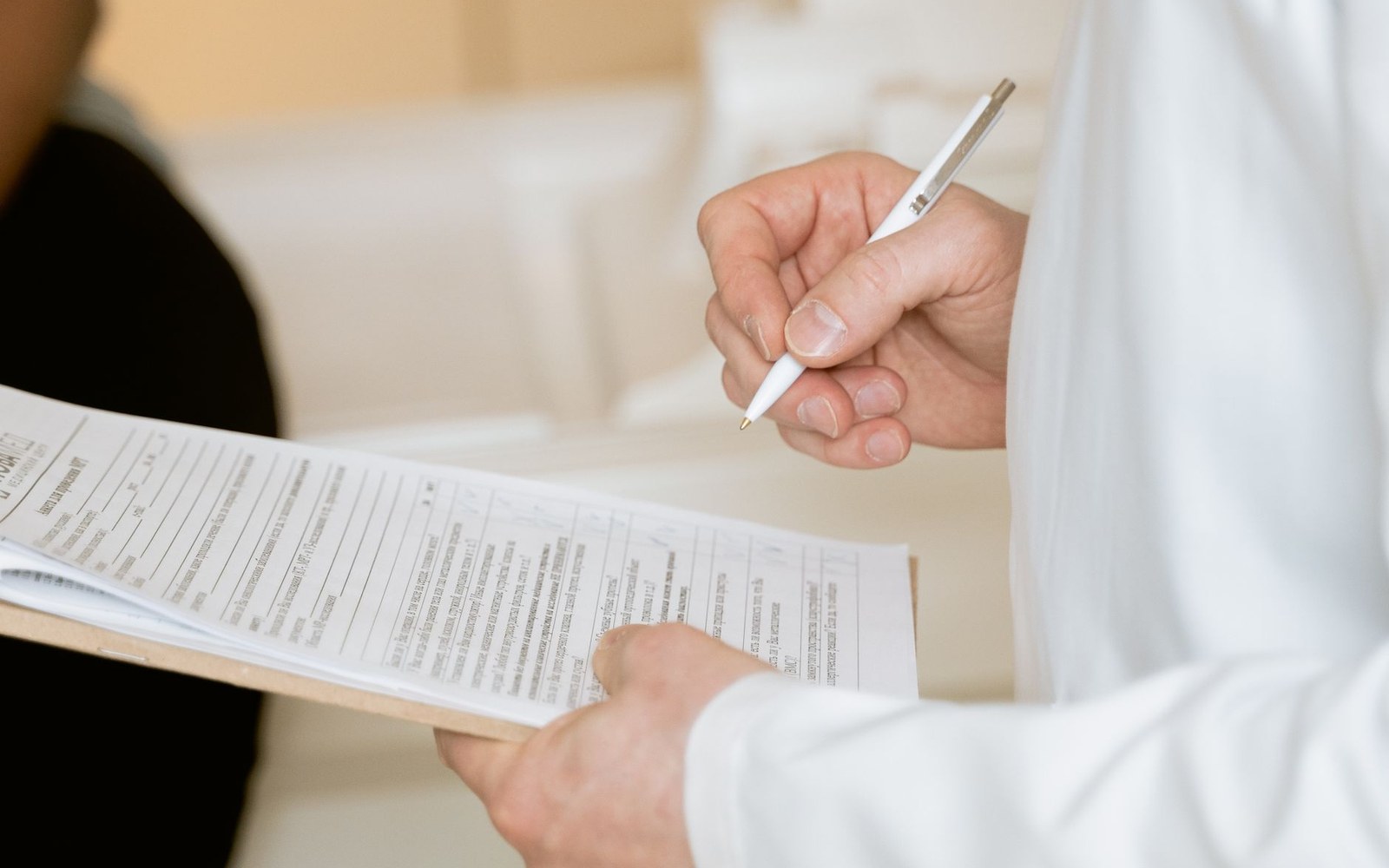 The NHMRC 2015 review open at its conclusions section, paragraph numbers visible, on a desk with a researcher's hand resting beside it